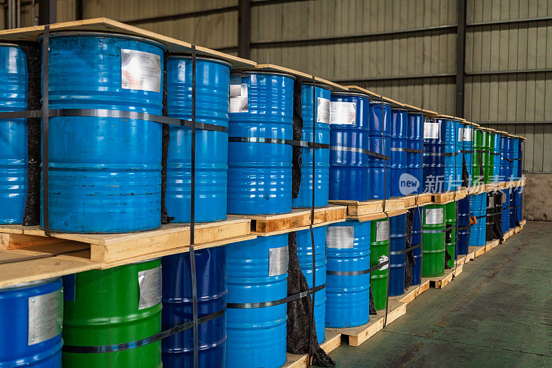 Blue Metal Oil Barrels Stacked In A Warehouse